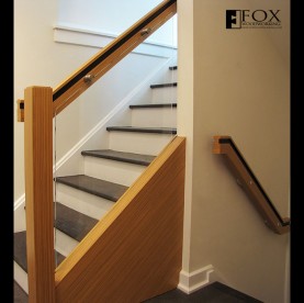 Teak veneered handrails and glass panel with stainless steel mounts.